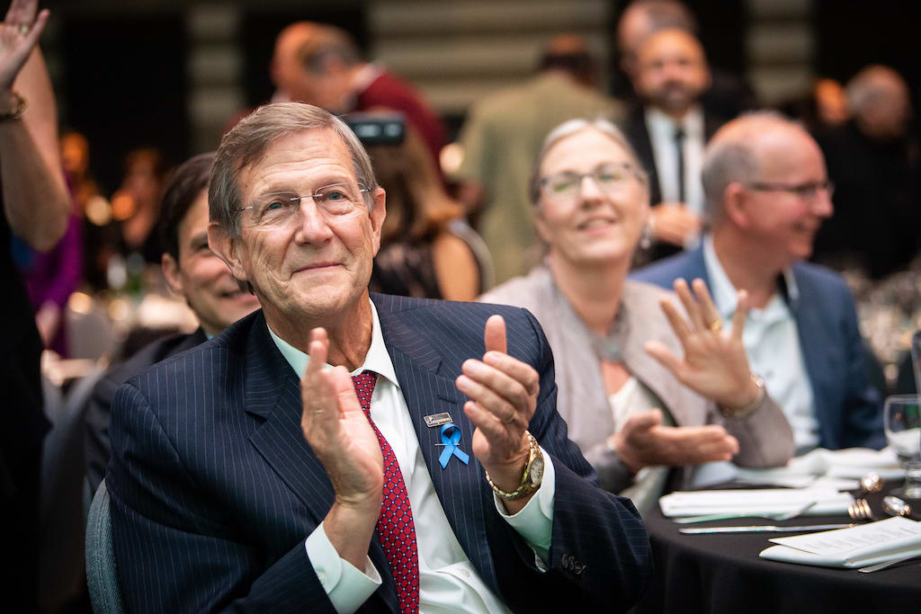 Dr. Wess Stafford offers applause during the event programme.
